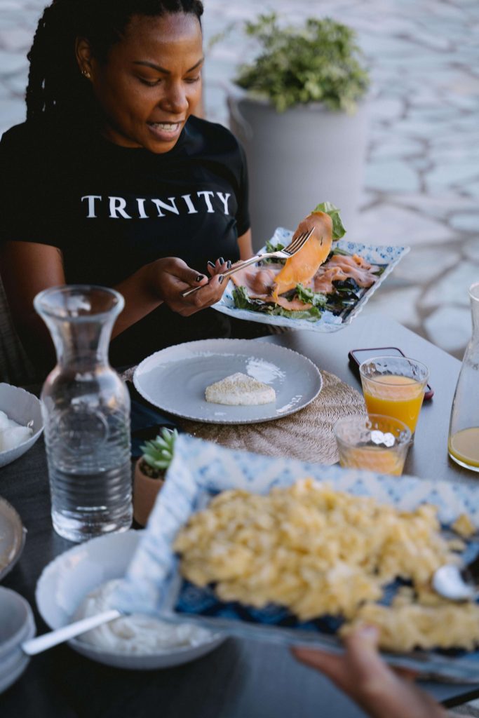 Is Magnesium Good For Menopause? One of our fitness coaches at Trinity putting a slice of salmon high in magnesium on to her plate. 