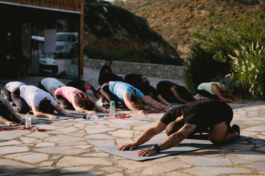 Strength exercise in menopause. A group training exercise doing the child's pose.