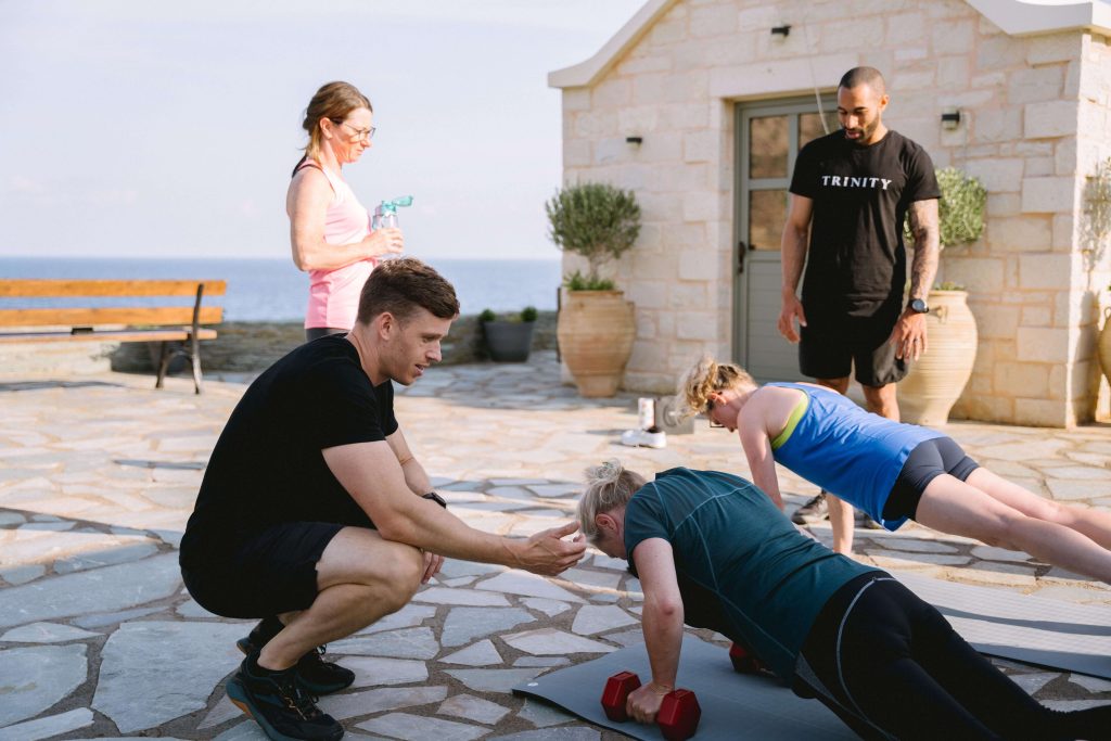 strength training in menopause, press-ups with dumbbells with a coach