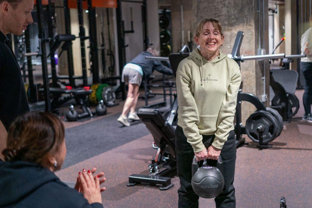 One of our clients in the gym performing a RDL using a kettlebell. An example of an exercise that could be used in a CrossFit workout for weight loss.